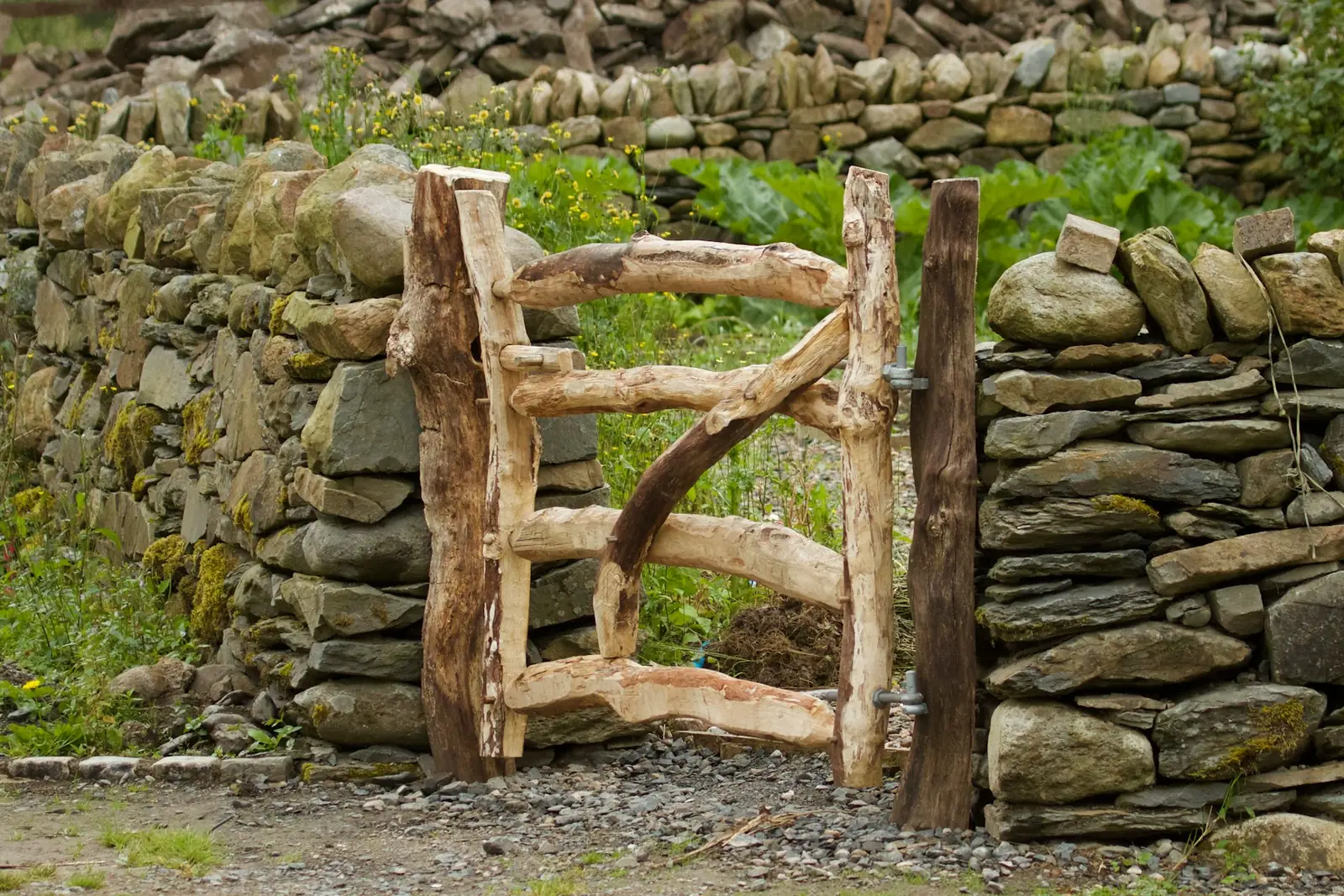 Rustic wooden gate in a dry stone wall
