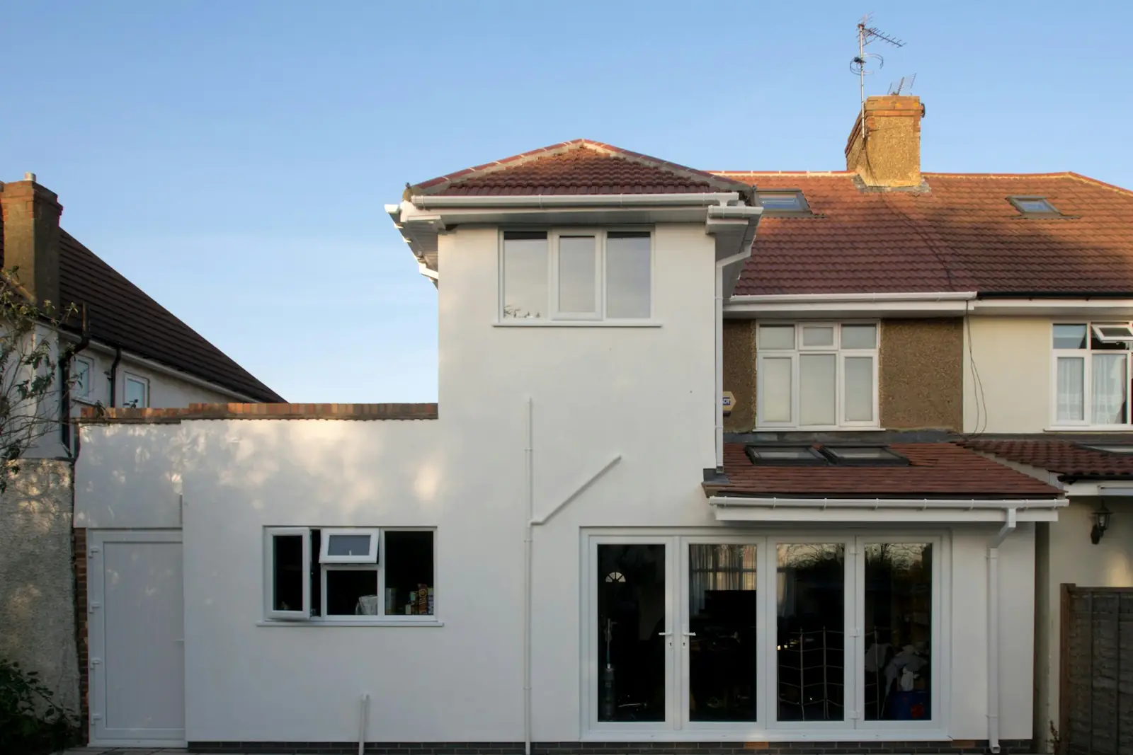 Finished single-storey rear extension with French doors on a British semi-detached house