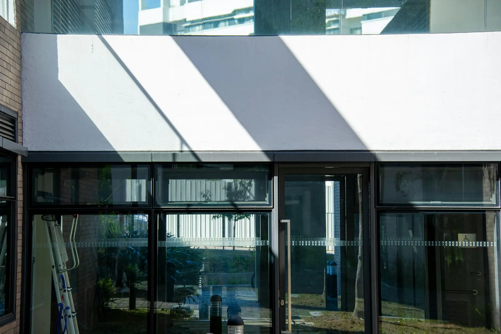White awning shading the glazed front of a modern building