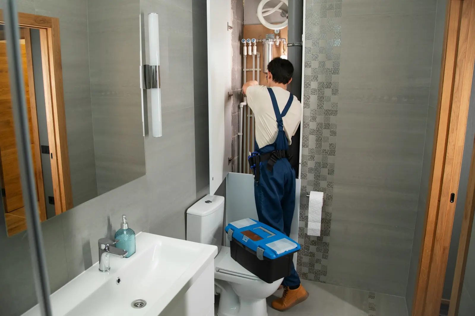 Plumber working in a modern bathroom