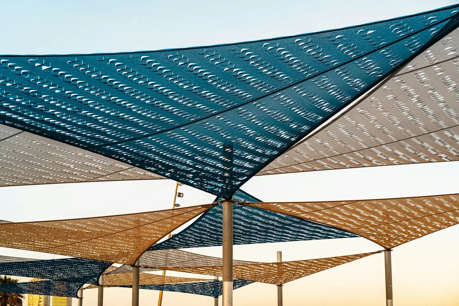 Overlapping triangular shade sails stretched above an outdoor space